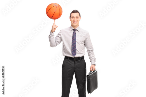 Businessman spinning a basketball on his finger