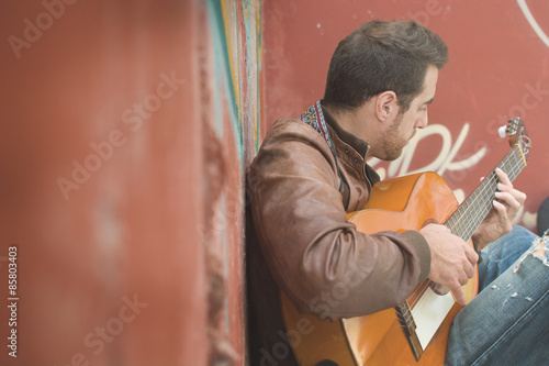 man with guitar in a ruined building. urban style