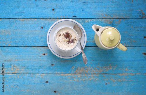 italian cappuccino and coffee pot on blue table, free copy space photo