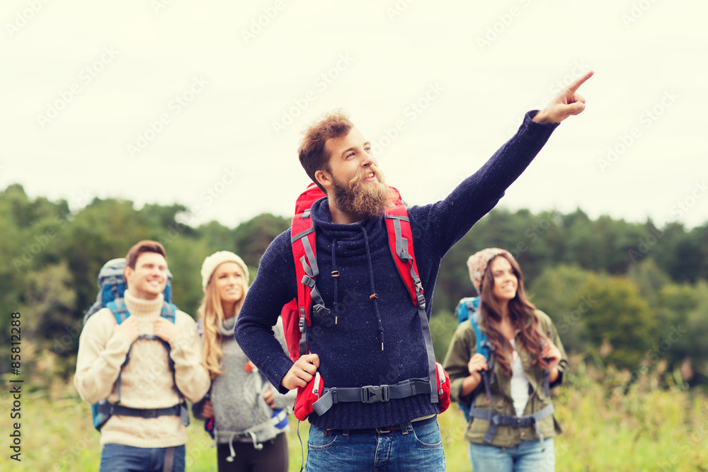 smiling hikers with backpacks pointing finger smiling hikers with backpacks pointing finger
