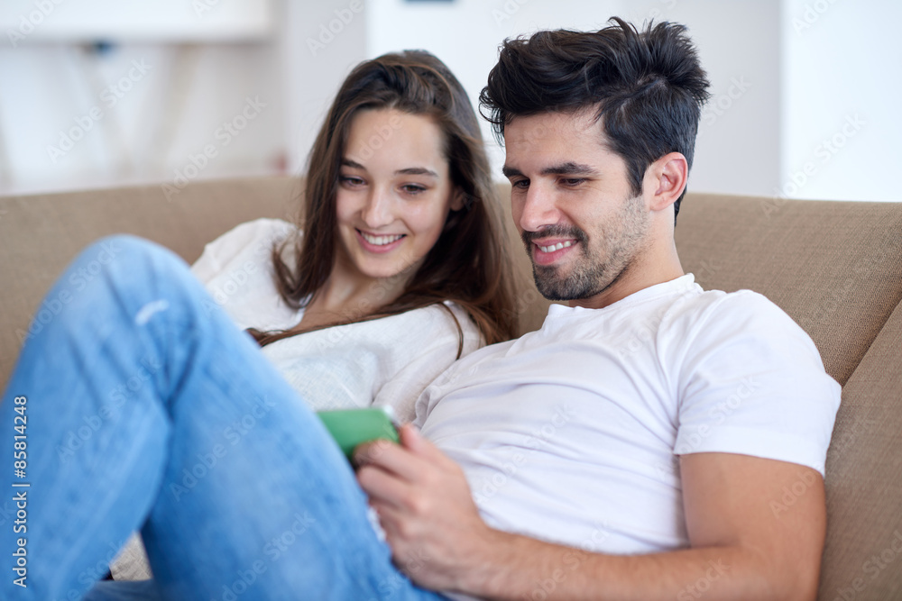 couple at modern home using tablet computer couple at modern home using tablet computer