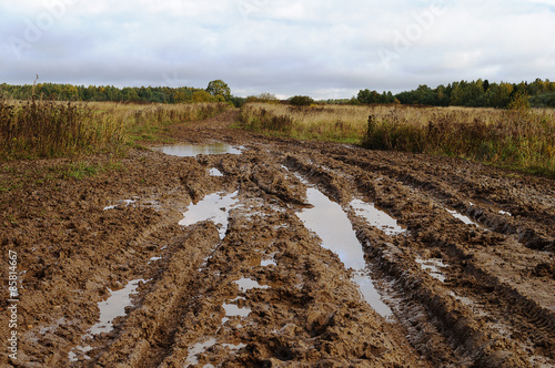 Messy rural dirt road after the rain photo