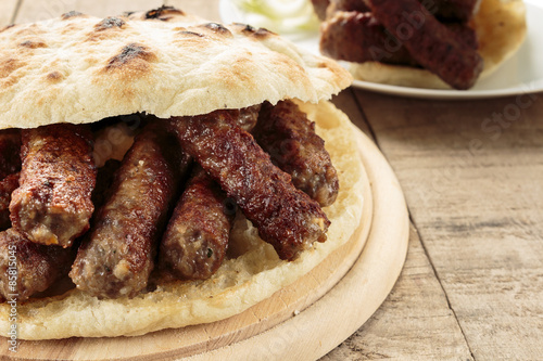 Cevapi (Cevapcici), Bosnian dish prepared on the barbecue and served with Lepinja bread. This dish is popular all over the Balkans, with tourists and locals.