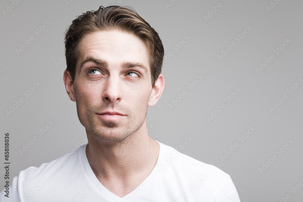 Thoughtful sly guy in white t-shirt Thoughtful sly guy in white t-shirt