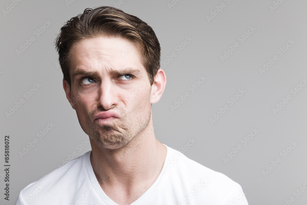 Doubting man in a white T-shirt Doubting man in a white T-shirt