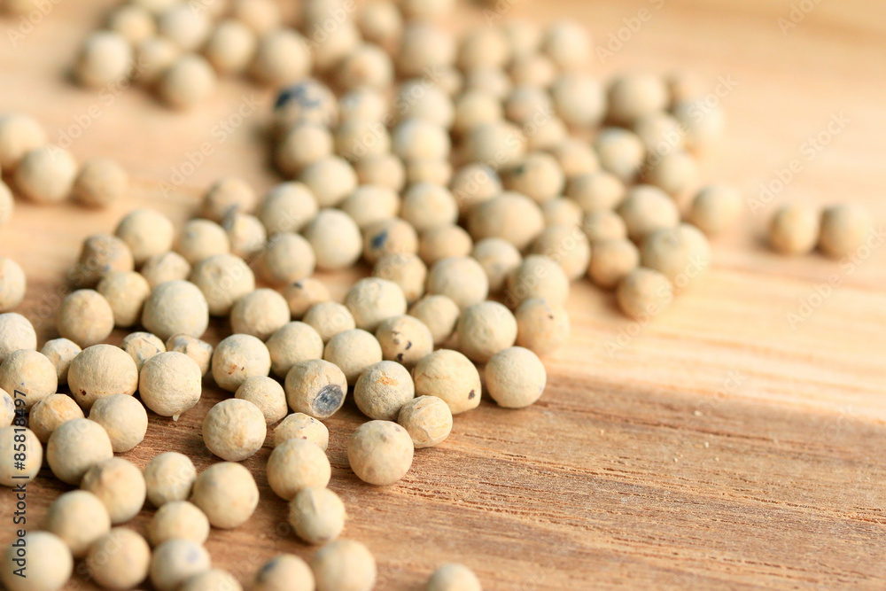white pepper seeds on wooden background. white pepper seeds on wooden background.