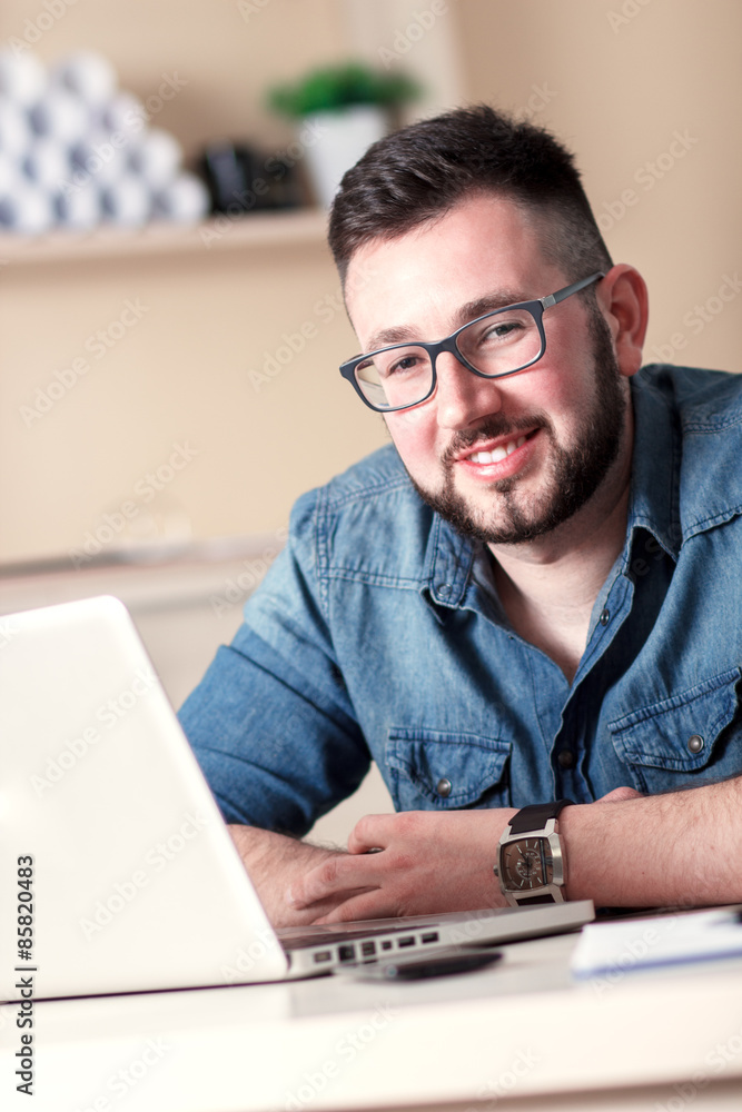 Portrait young businessman in his office Portrait young businessman in his office