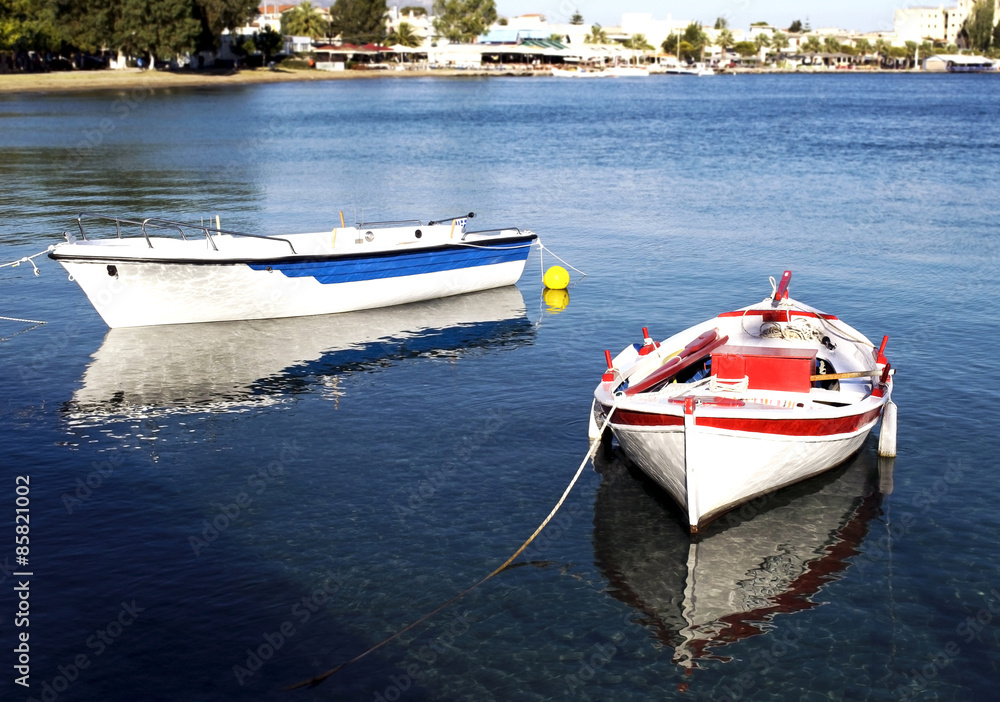 Fototapeta premium two fishing boats with water reflections