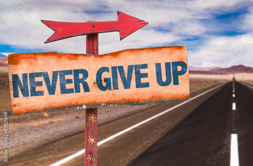 Bild auf Leinwand Never Give Up sign with road background