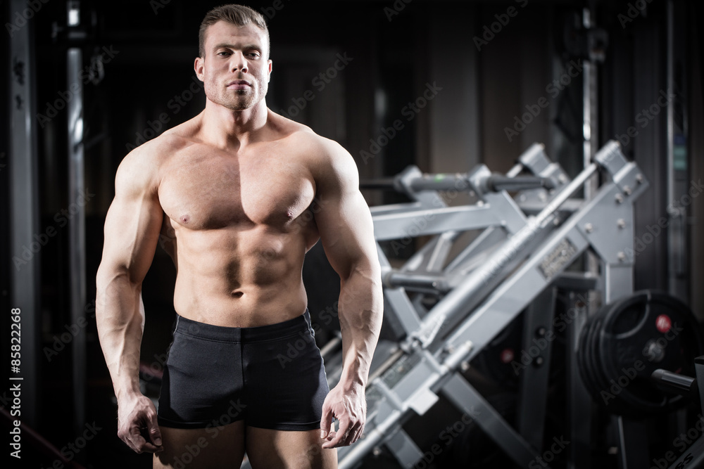 Strong man doing bodybuilding in gym