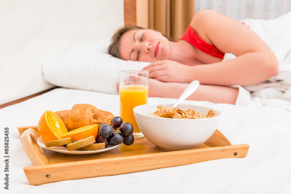 sleeping woman and a tray with breakfast