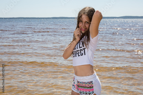 Lovely young girl posing for the camera on holidays photo