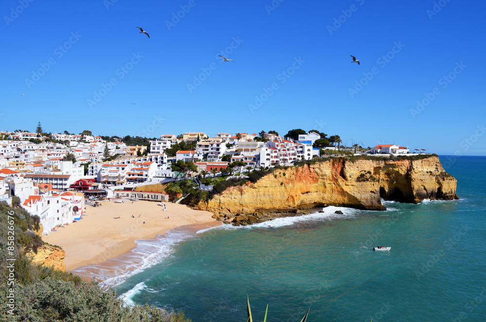 View of Praia da Carvoeiro beach and village from the cliffs. Carvoeiro is a well know destination for tourists in western Algarve, Portugal.