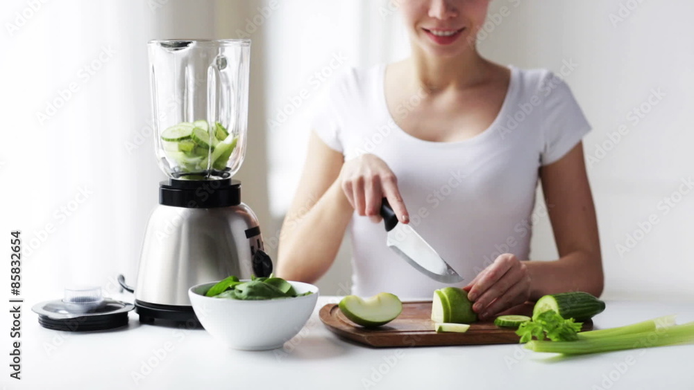 smiling woman with blender chopping vegetables smiling woman with blender chopping vegetables