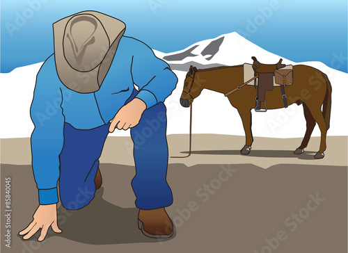 Dismounted cowboy tracker looking for clues on the ground