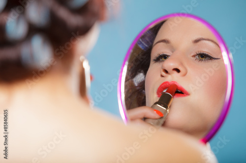  Girl applying make up red lipstick