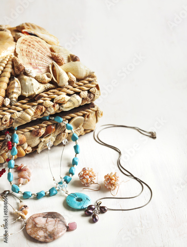 A collection of jewelry in jewelry box decorated with seashells