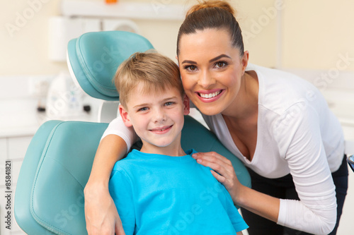 mother hugging her son in dentist office