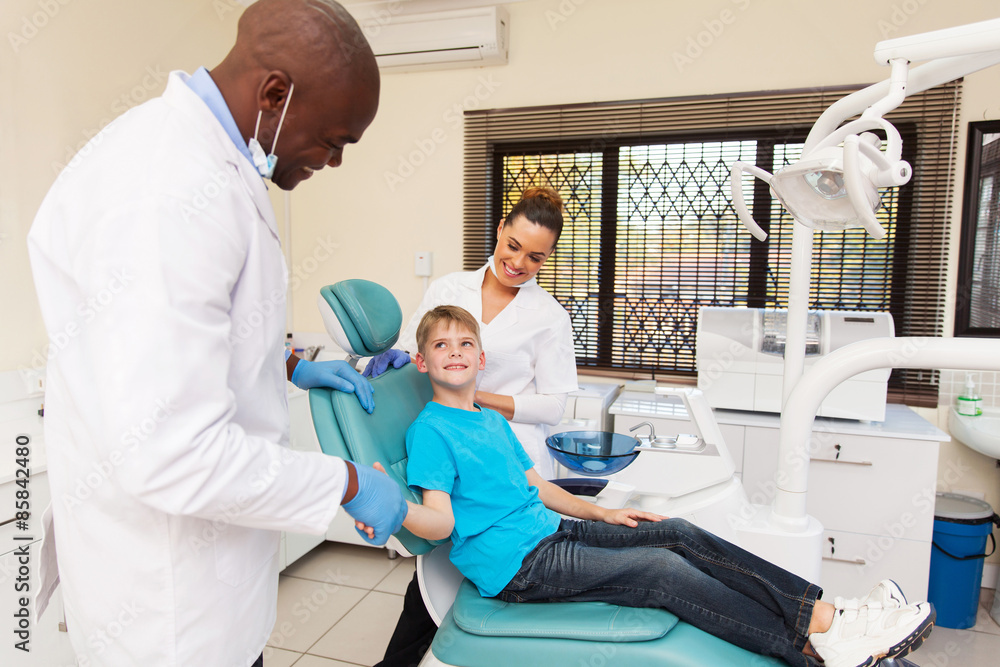 dentist congratulate little boy for a successful operation dentist congratulate little boy for a successful operation