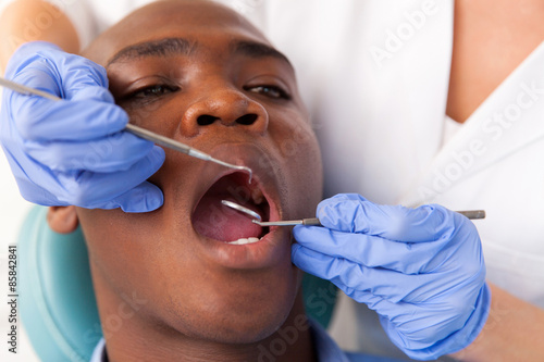 african male patient getting dental treatment