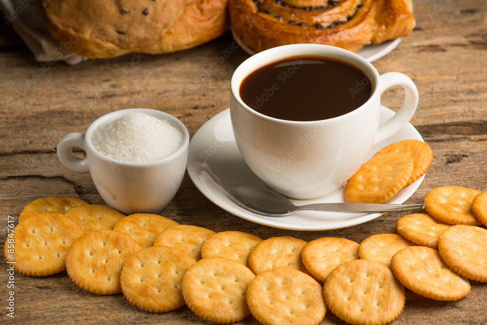 Cup of coffee on a wooden board and biscuits Cup of coffee on a wooden board and biscuits