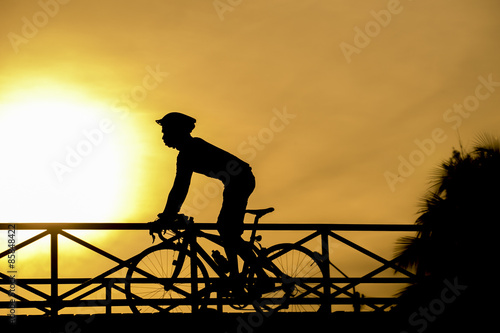 Fototapeta Naklejka Na Ścianę i Meble -  silhouette of biker on Bridge and sunset