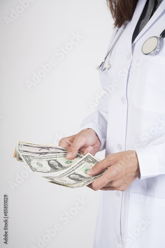 doctor counting dollar banknotes