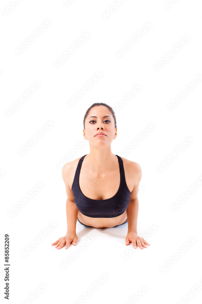 Beautiful young woman making a Yoga pose: Bhugangasana, The Cobra Pose Beautiful young woman making a Yoga pose: Bhugangasana, The Cobra Pose
