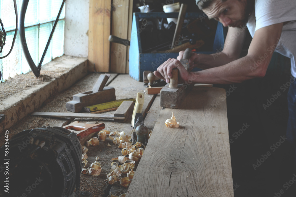 Woodworker while working in the studio Woodworker while working in the studio