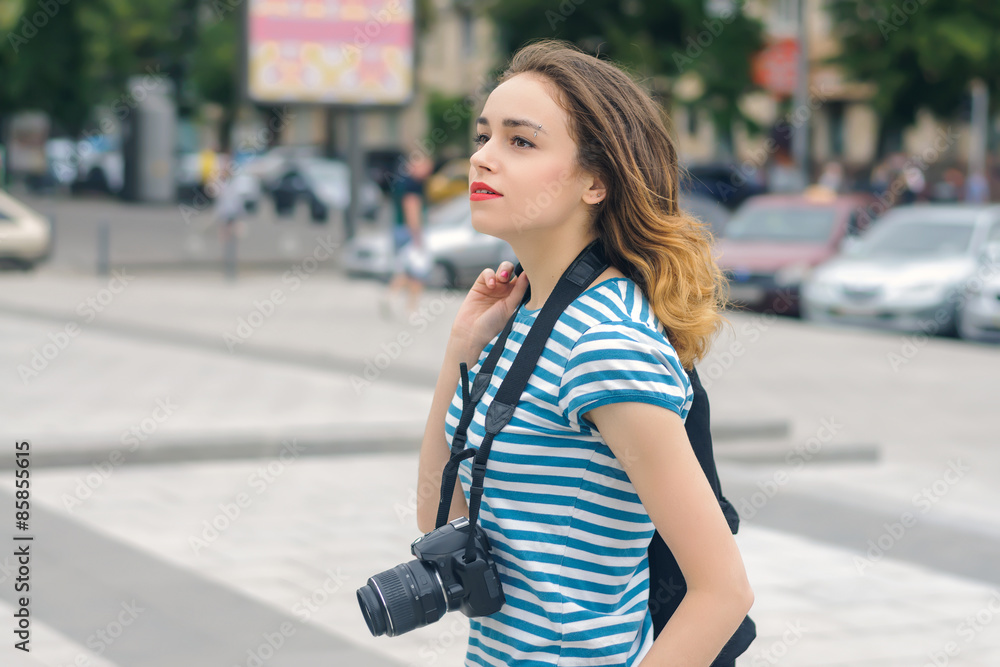 Fototapeta premium Woman photographer walking down the street