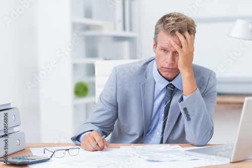 Businessman with his hand on his forehead
