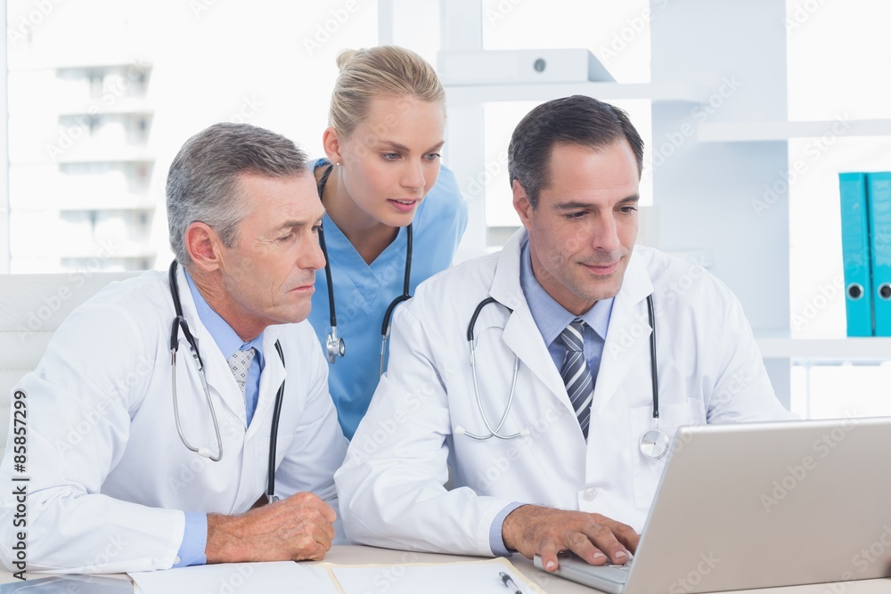 Doctors and nurse working with computer Doctors and nurse working with computer