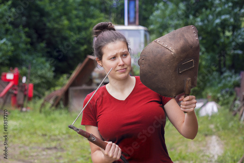 Girl in red with a welding machine