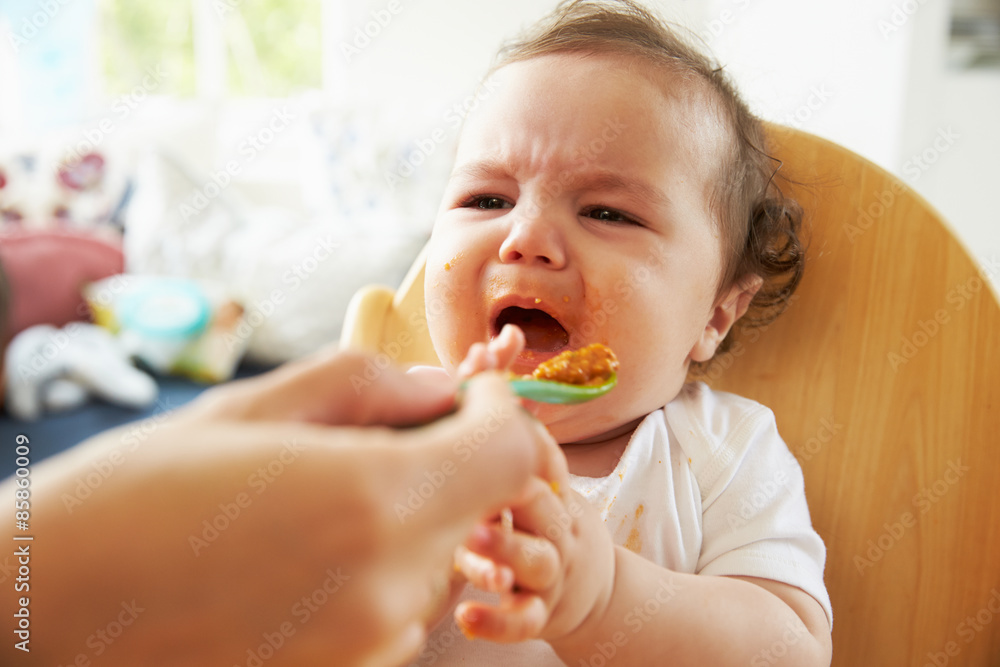Ταπετσαρία Unhappy Baby Being Fed In High Chair At Meal Time