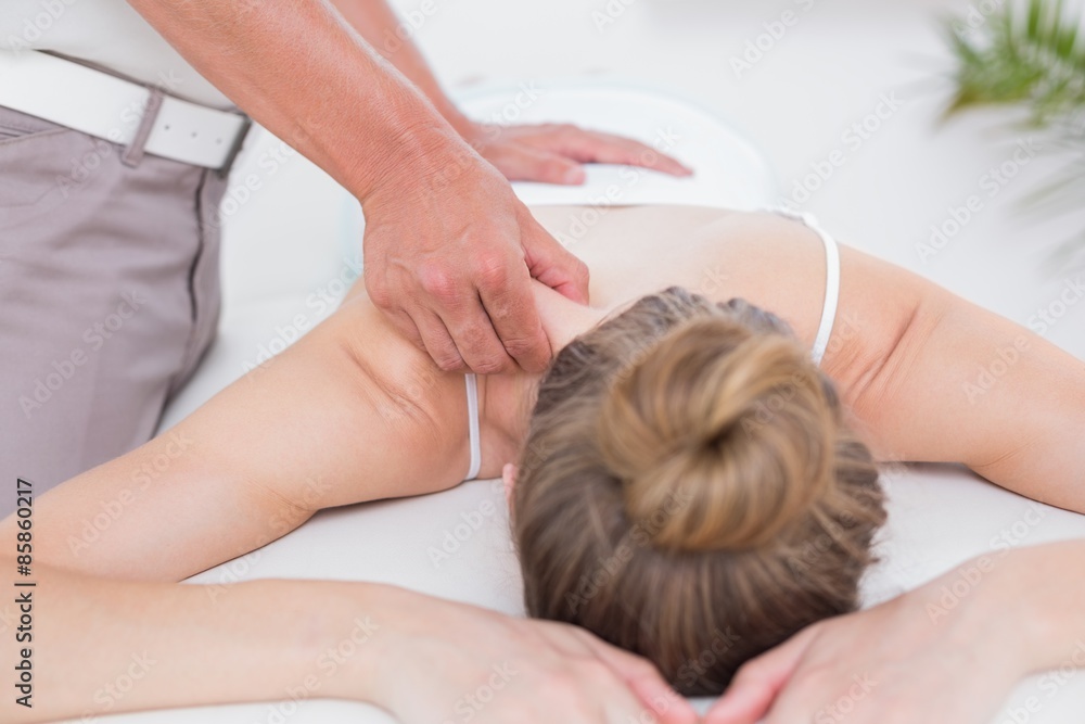 Physiotherapist doing shoulder massage Physiotherapist doing shoulder massage