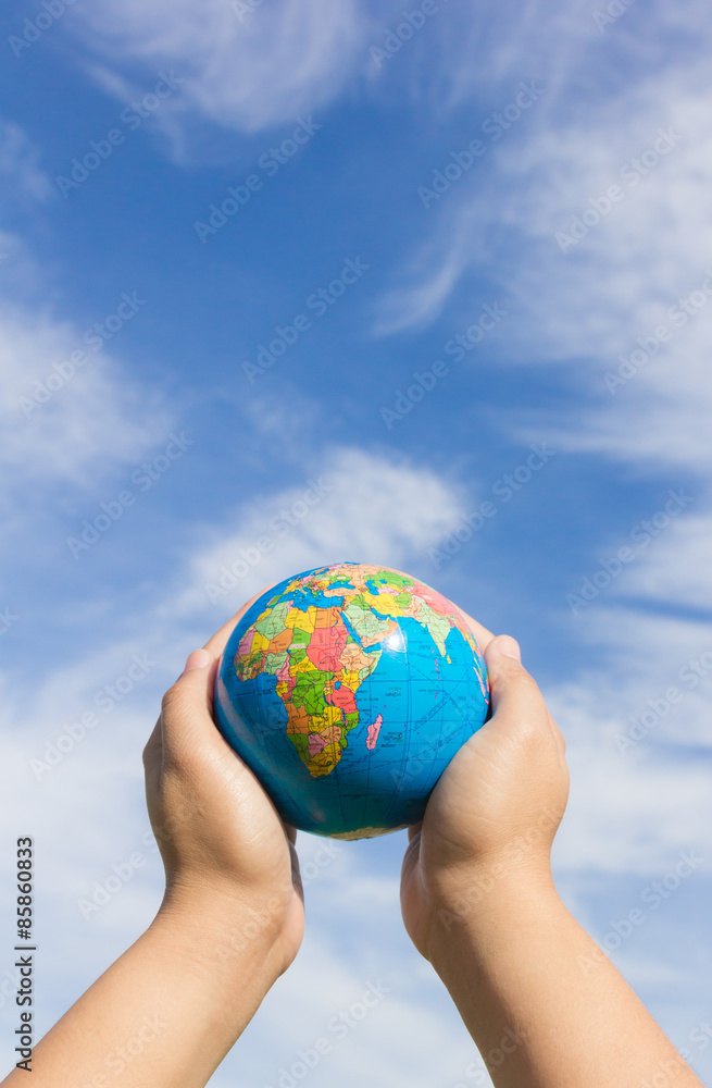 hands holding globe with sky background hands holding globe with sky background