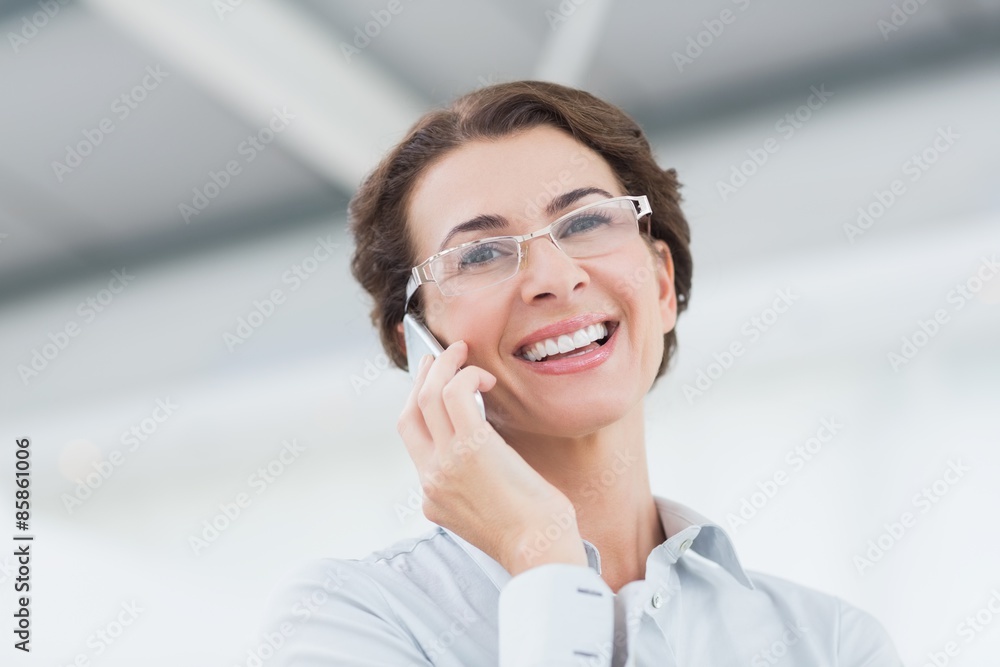 Smiling businesswoman on the phone wearing eye glasses Smiling businesswoman on the phone wearing eye glasses