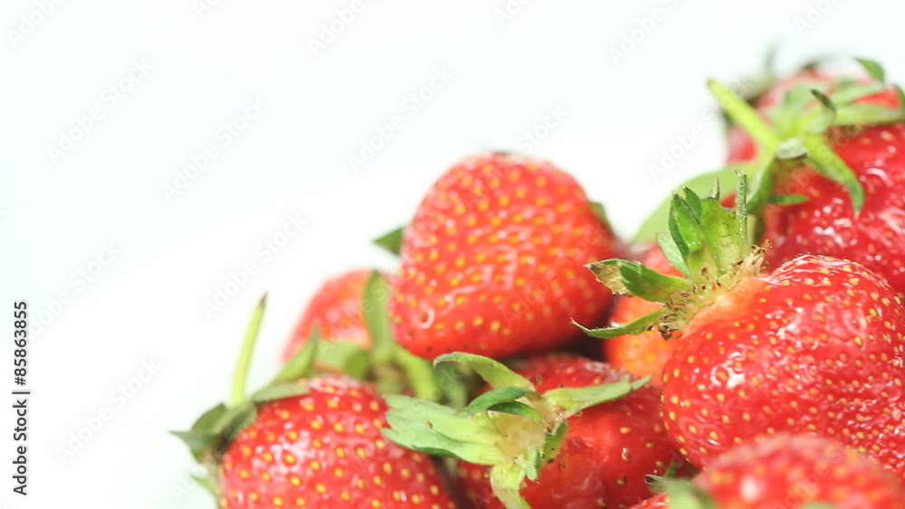 Fresh red strawberries rotating (away from the camera) in a seamless loop, copy space available in top left part of screen, white background Fresh red strawberries rotating (away from the camera) in a seamless loop, copy space available in top left part of screen, white background