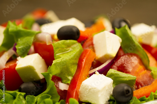 summer Greek salad with olives and feta cheese, closeup