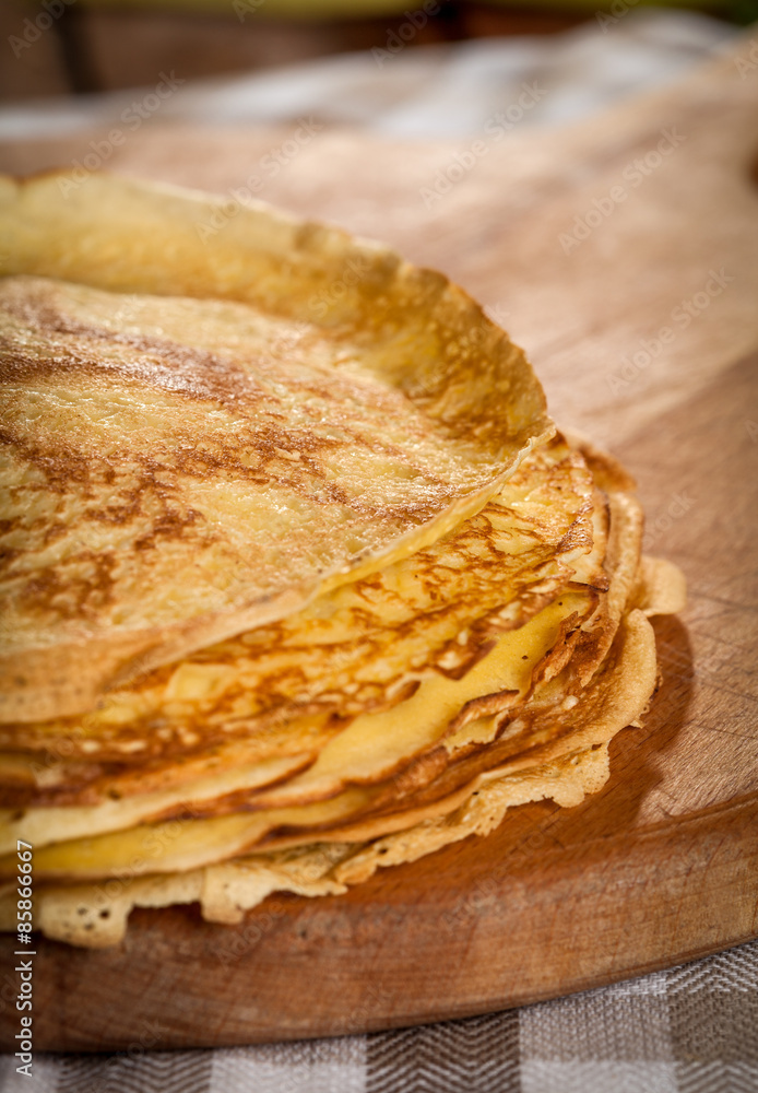 Stack of pancakes on a wooden board Stack of pancakes on a wooden board
