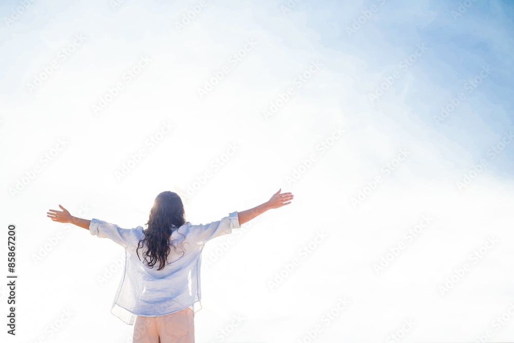 Happy woman with arms outstretched at the beach Happy woman with arms outstretched at the beach