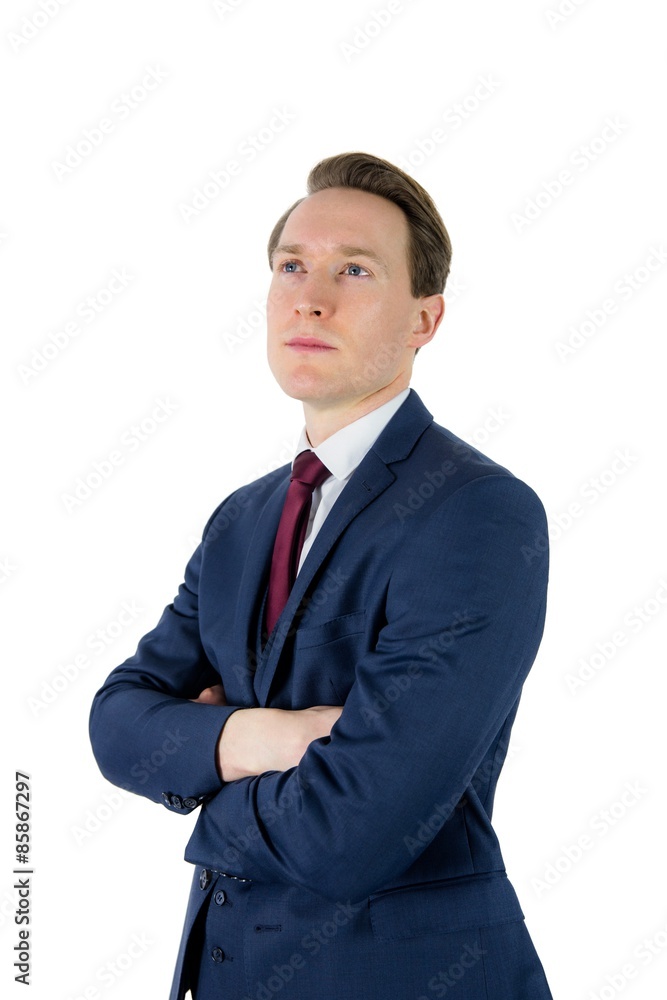 Thoughtful businessman looking away with arms crossed Thoughtful businessman looking away with arms crossed