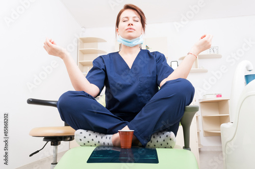 Wallpaper Mural Dentist woman meditating with yoga and lotus position Torontodigital.ca