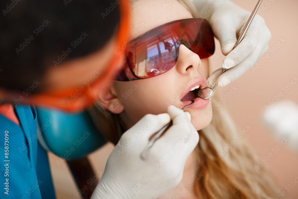 Dentist and female pacient at dental clinic tooth care