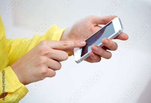 close up of female hands with smartphone at home