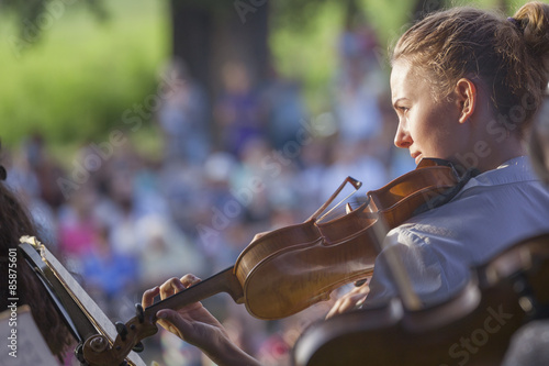 Young woman playing the violin at outdoors