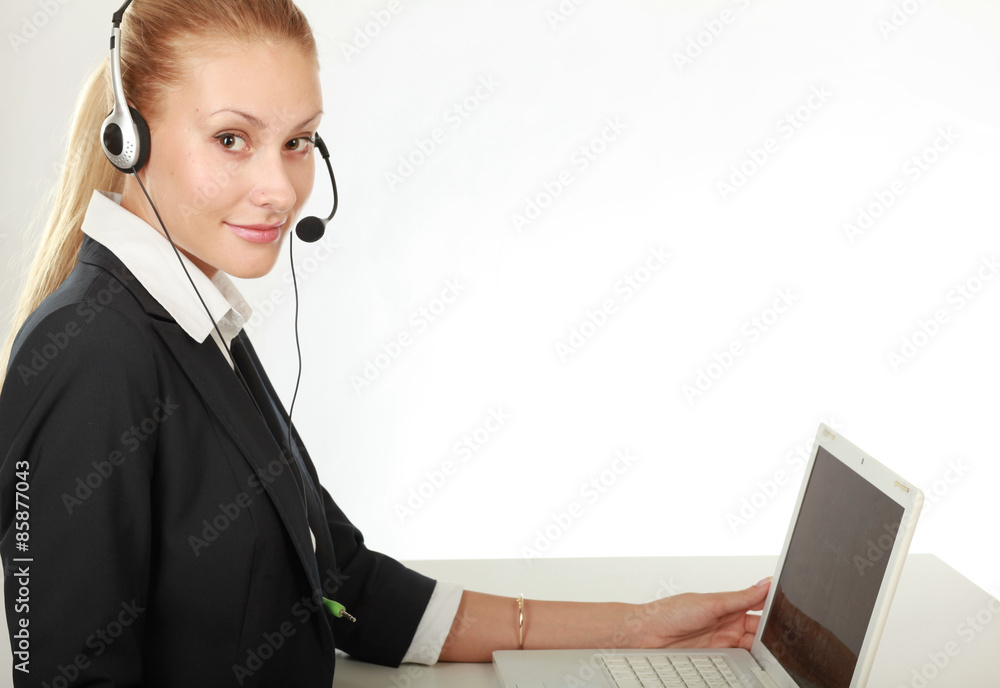 Female call center operator with headphone browsing on her Female call center operator with headphone browsing on her