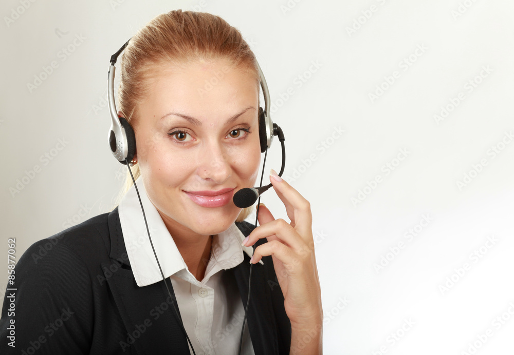 Female call center operator with headphone browsing on her Female call center operator with headphone browsing on her