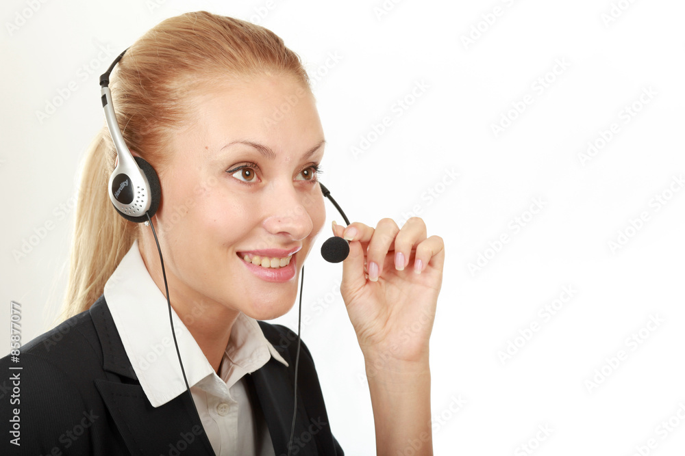 Female call center operator with headphone browsing on her Female call center operator with headphone browsing on her