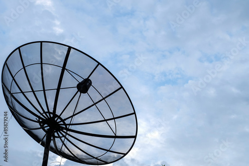 Satellite dish on cloudy sky backgound